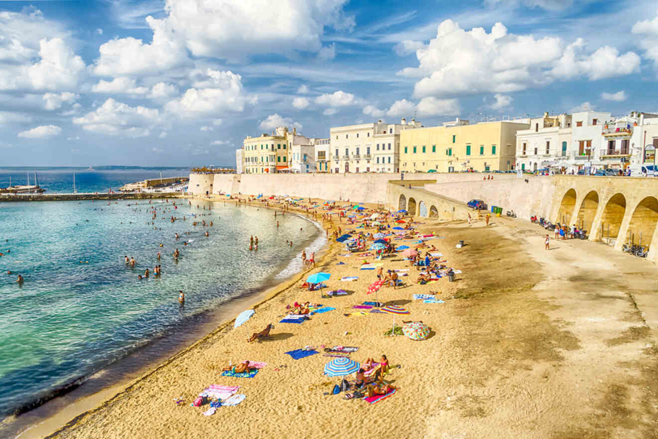 A beach with a lot of people on it.