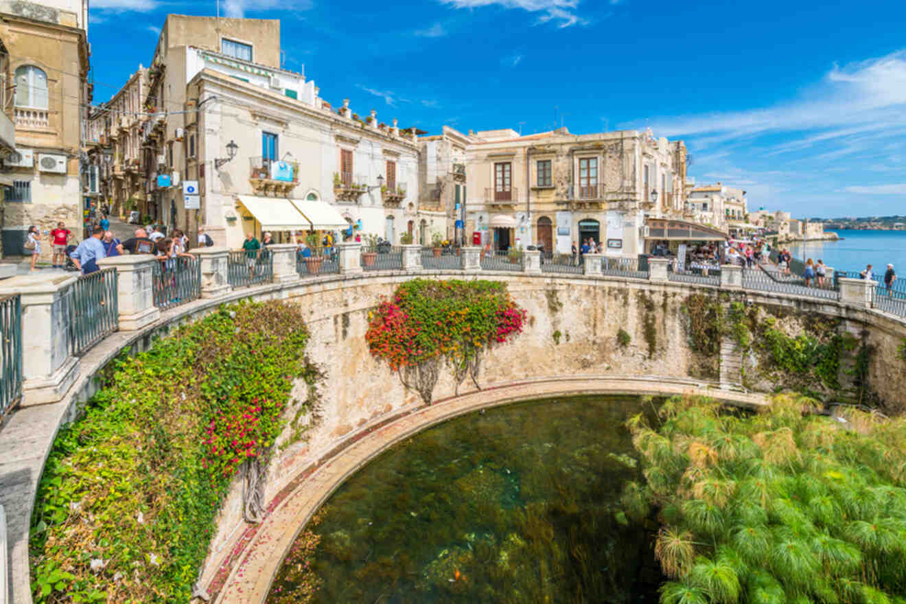 A city with a canal in the middle of it.