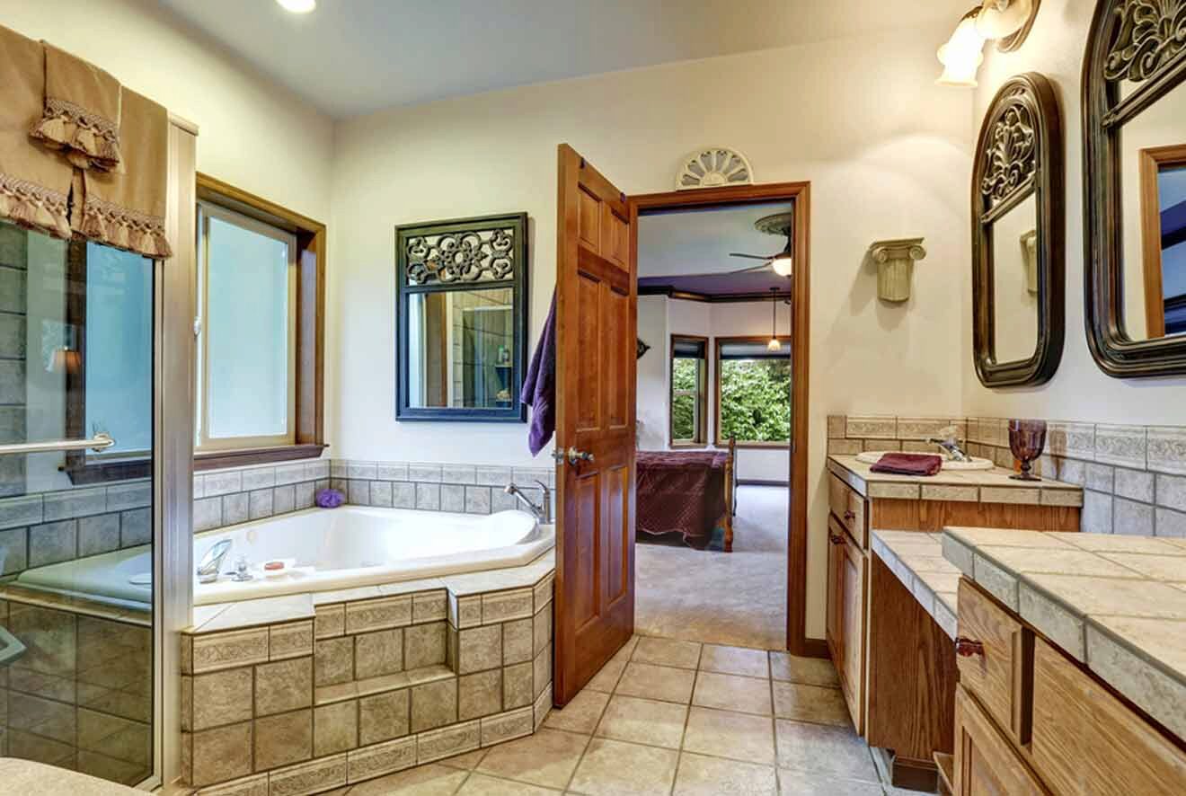 A bathroom with a jacuzzi tub and two sinks.