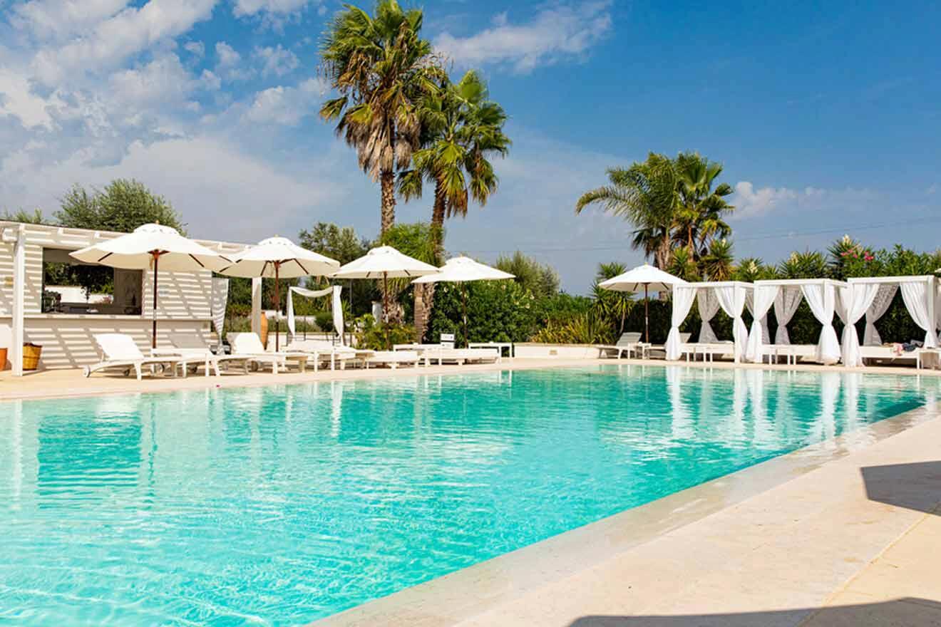 A swimming pool with lounge chairs and umbrellas.