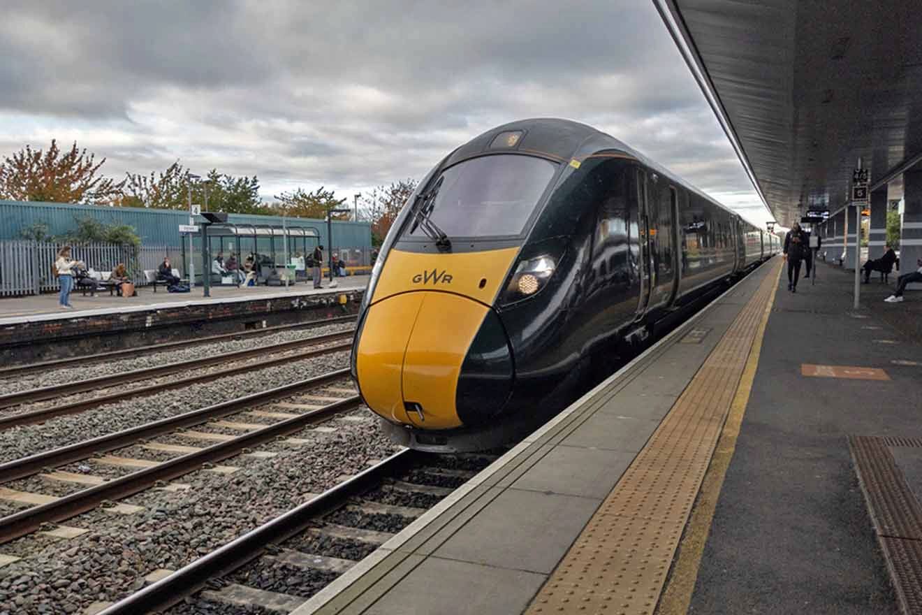 A yellow and black train on a platform.