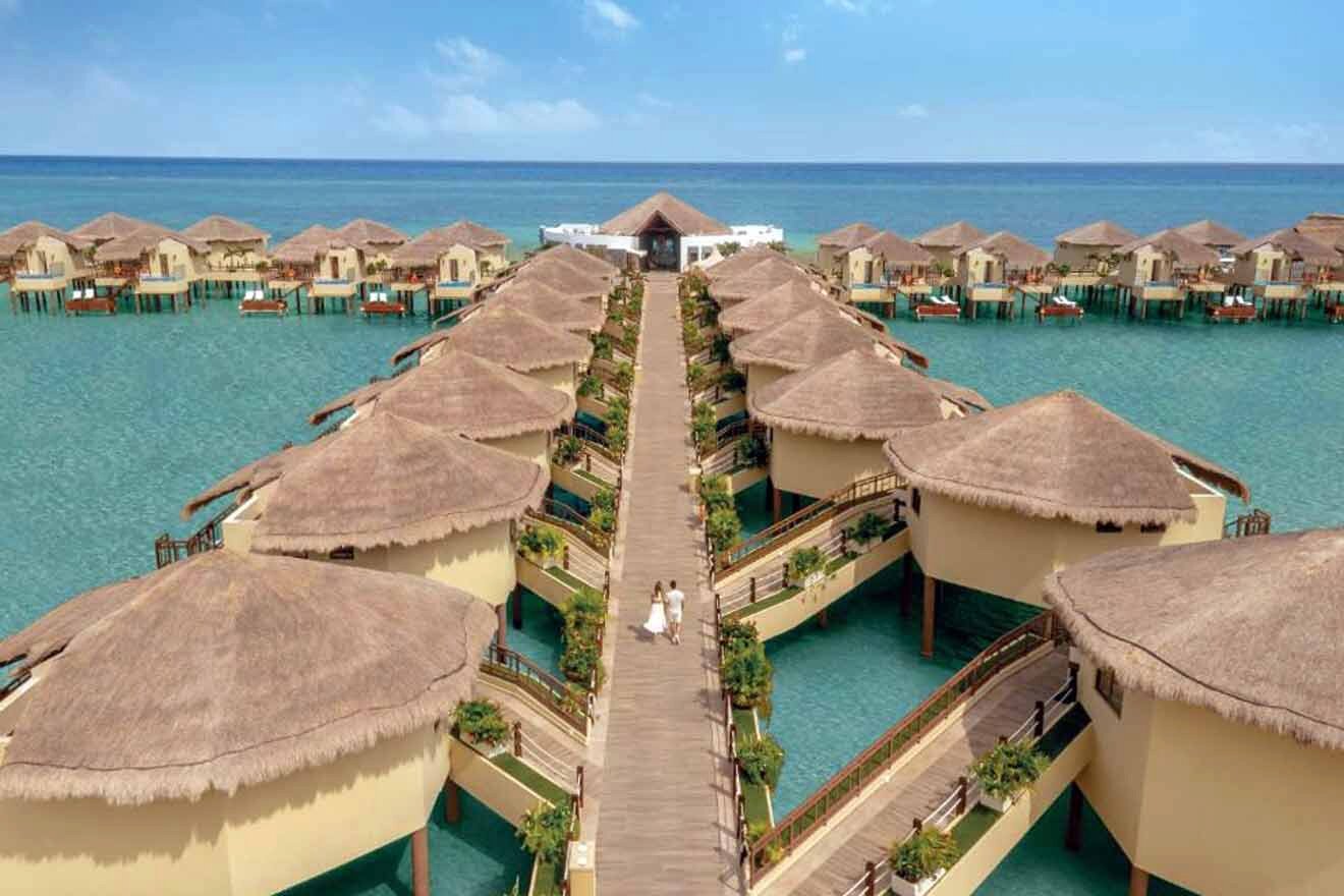 An aerial view of a resort with thatched huts.