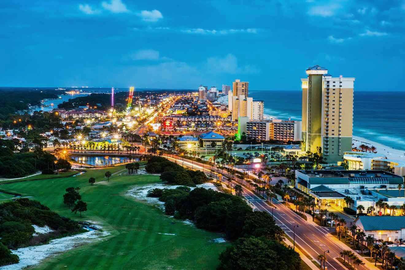 A view of the beach and city at dusk.