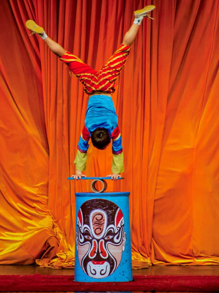 man doing handstand on box