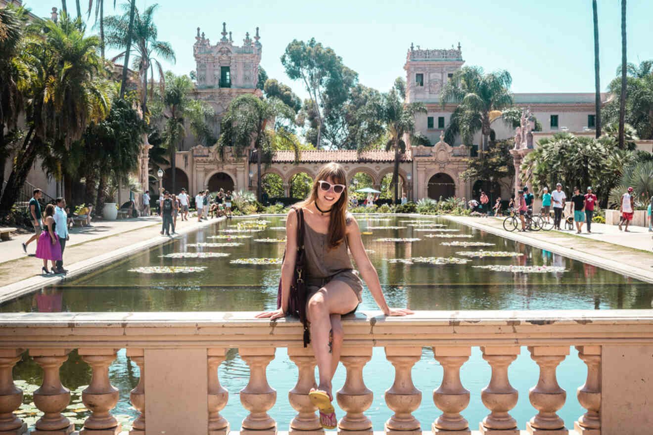 a girl sitting on a bridge at Balboa Park