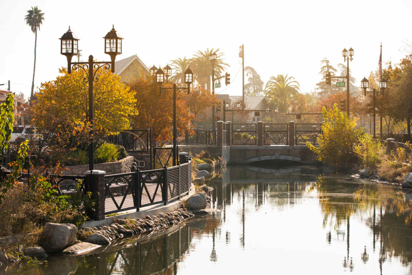 A canal with trees and a bridge.