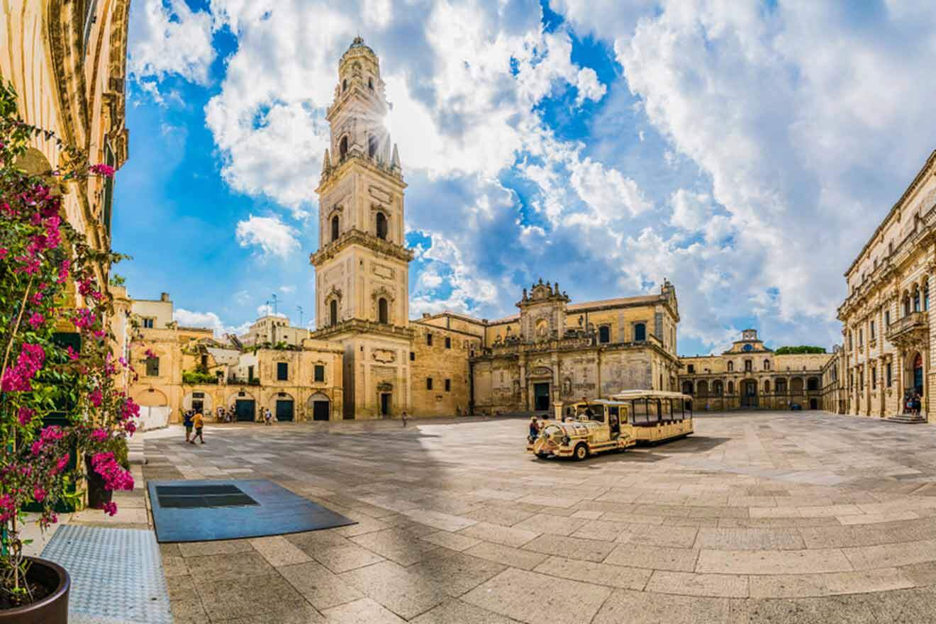 A city square with a tower in the background.