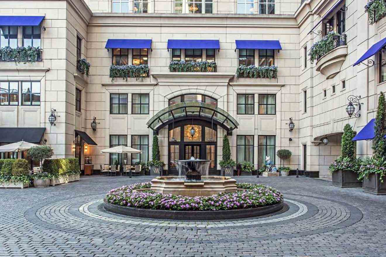 A courtyard with a fountain and blue awnings.