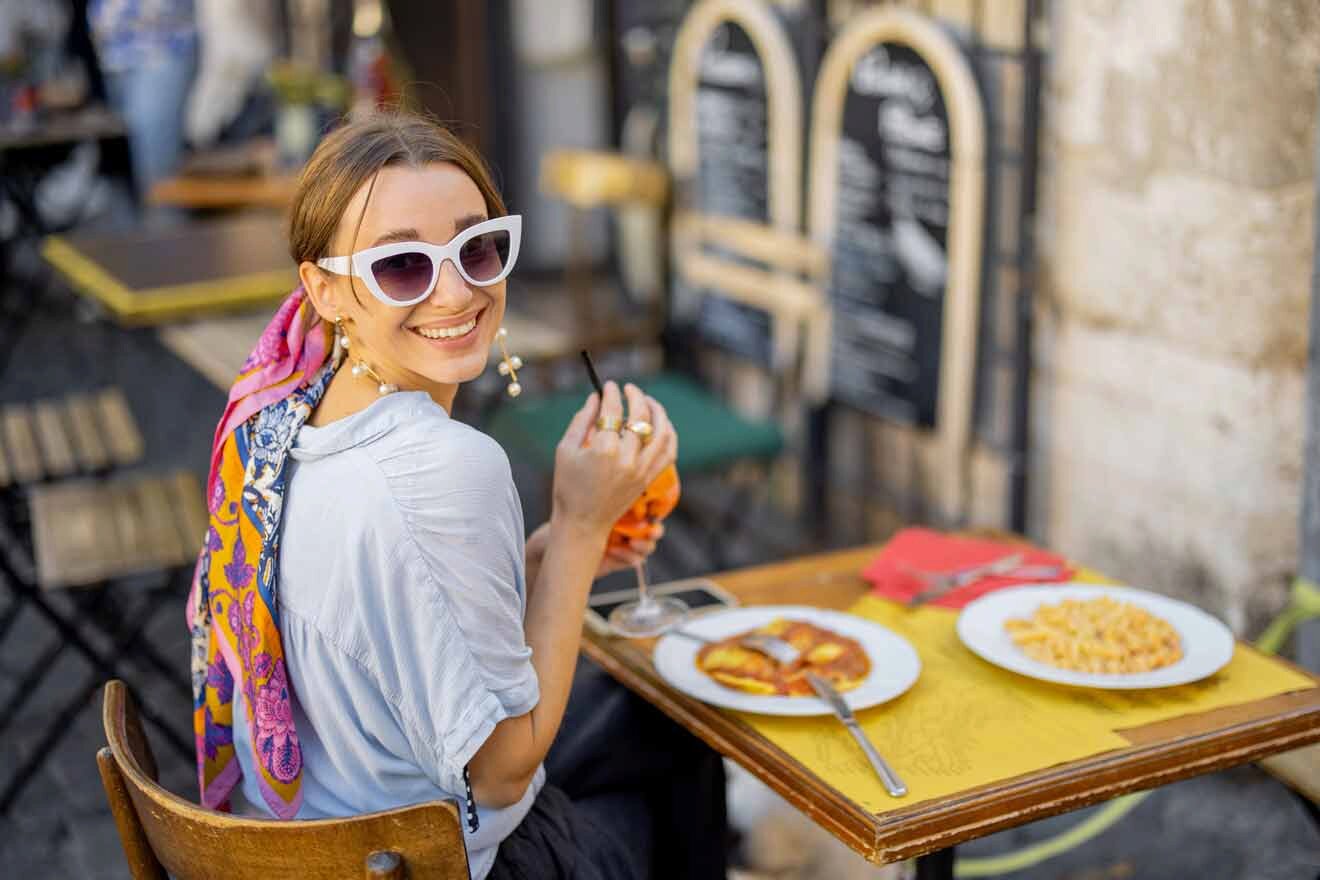 woman at a table in a street restaurant