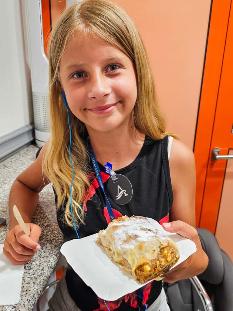 Girl eating an apple strudel