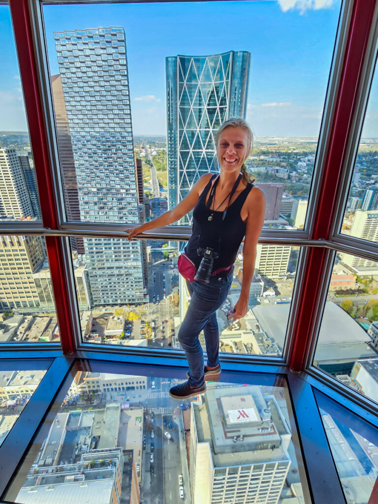 caz standing on glass floor of calgary tower