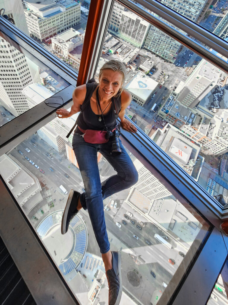 caz sitting on floor of glass ledge in calgary tower