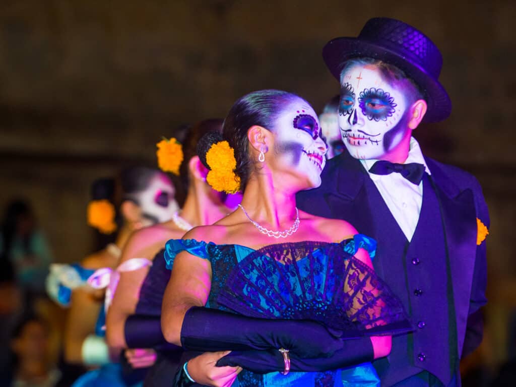 Man and woman dressed up with face paintings for a festival in Mexico