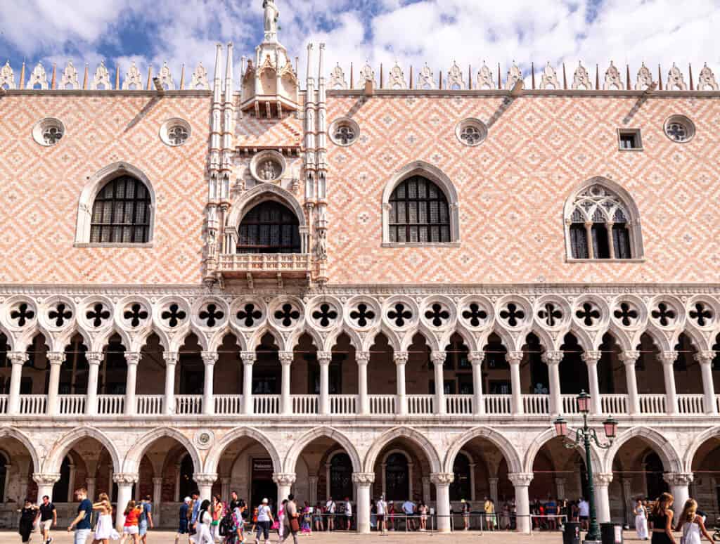 people walking in front of pink doges palace