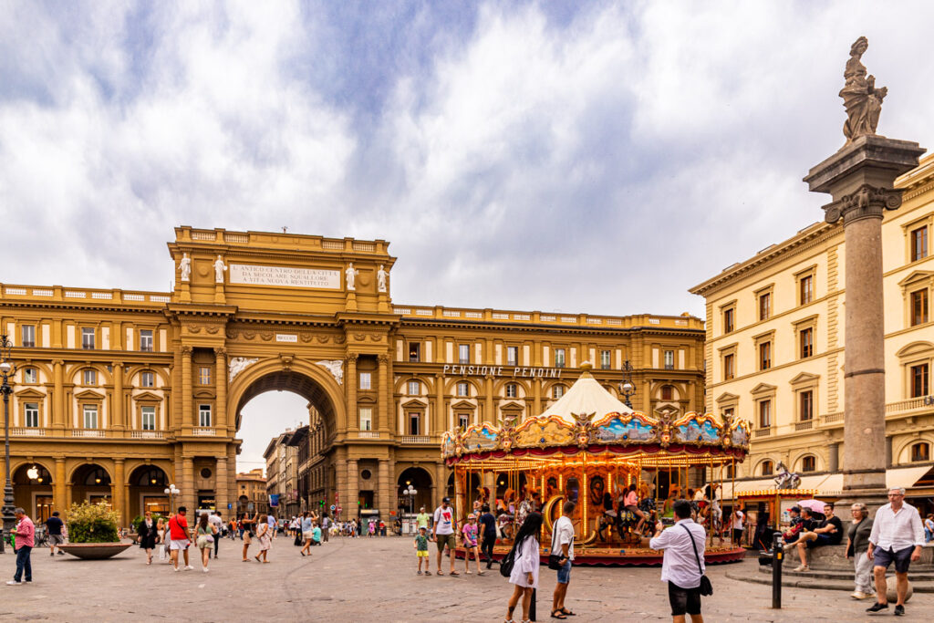 square with old buildings and carousel