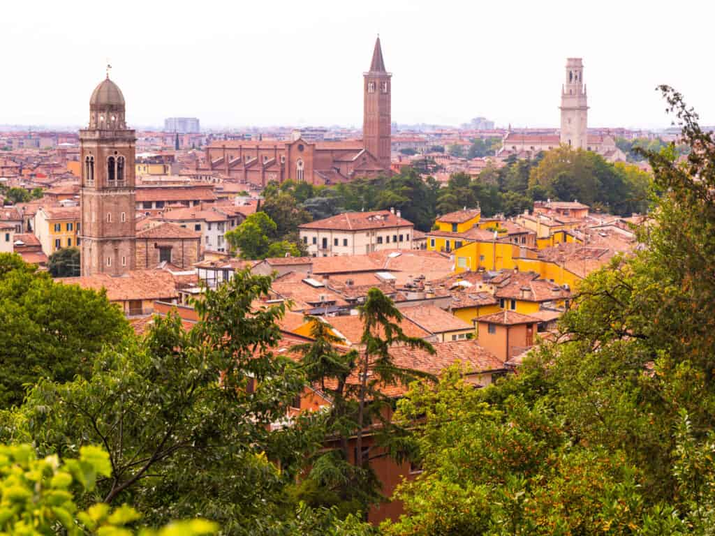 view of orange buildings and church steeple of verona 