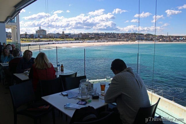 people sitting at tables on a balcony