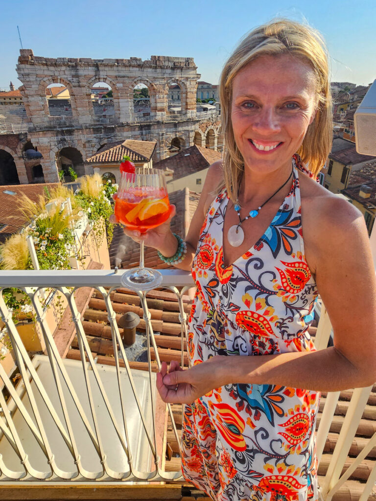 caz with aperol spritz enjoying view of  verona arena