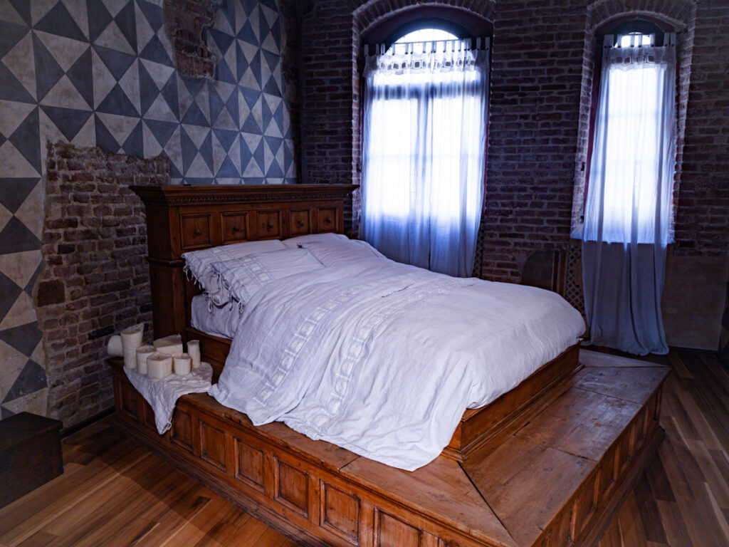 bed in middle of medieval room