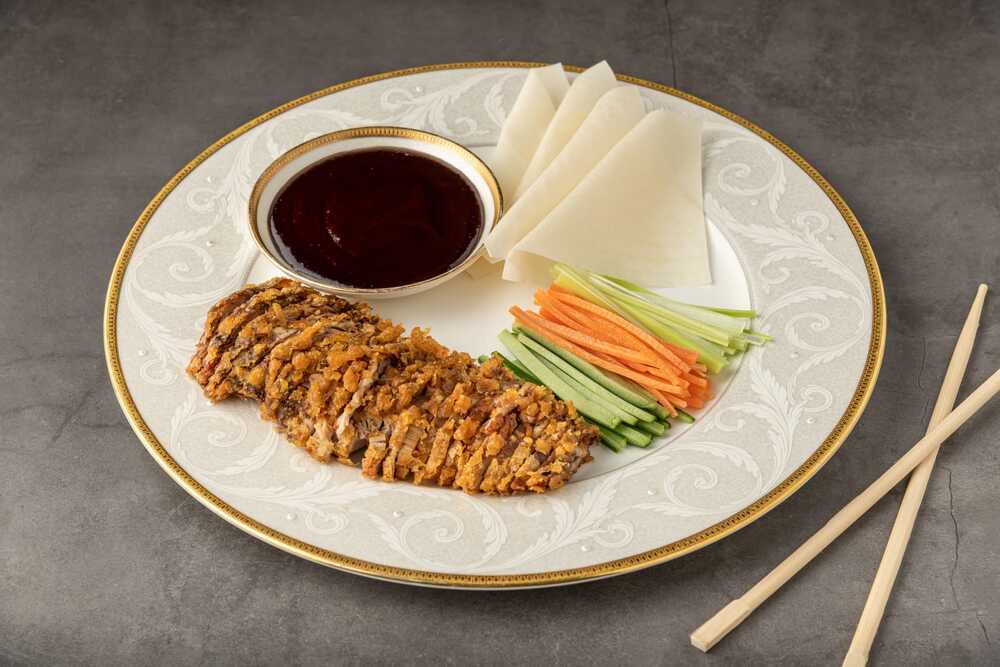 plate of peking duck with dipping sauce