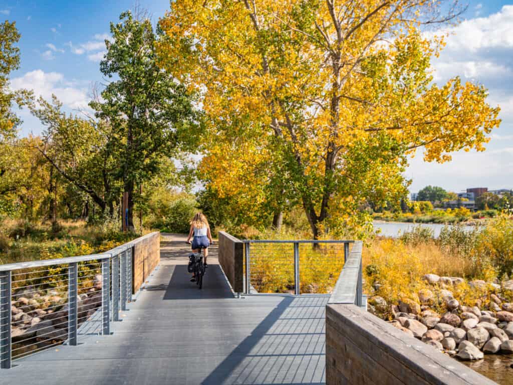 bike crossing bridge on St Partrick's island with yellow trees