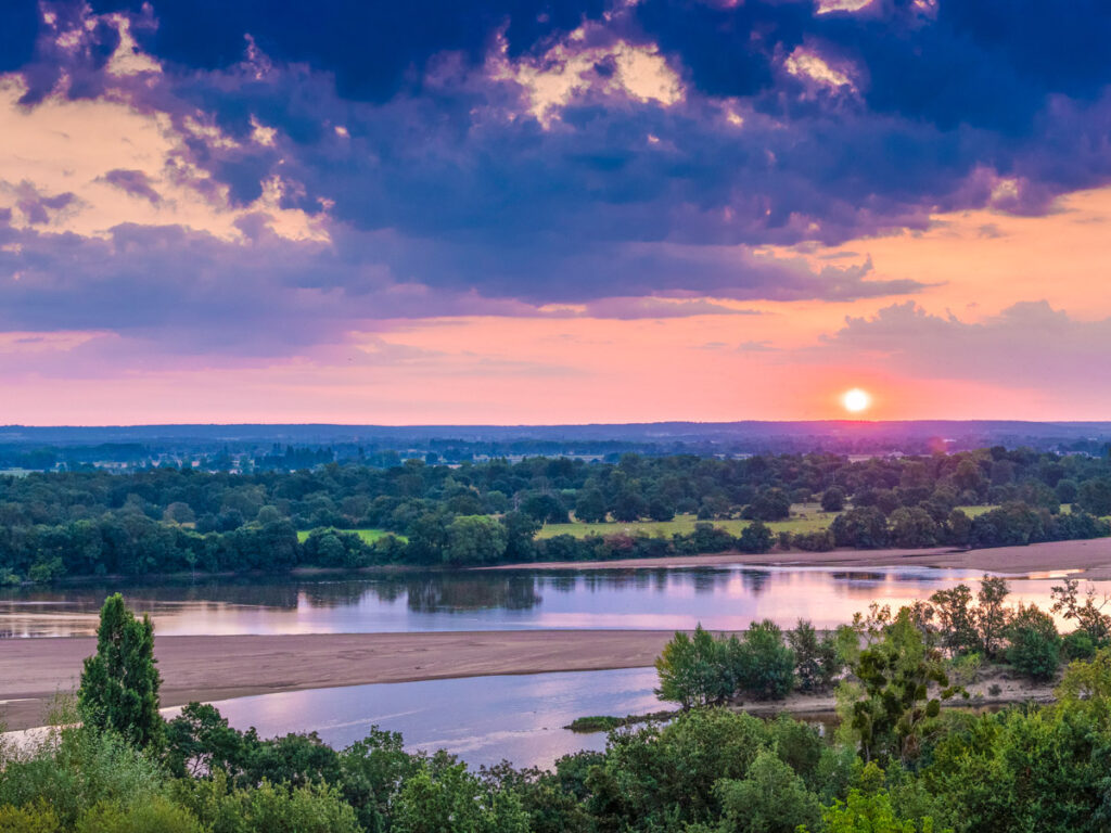 colorful sunrise over river loire and landscape around it 