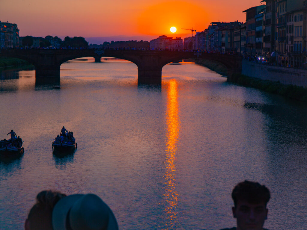 orange sunset over arno river in florence