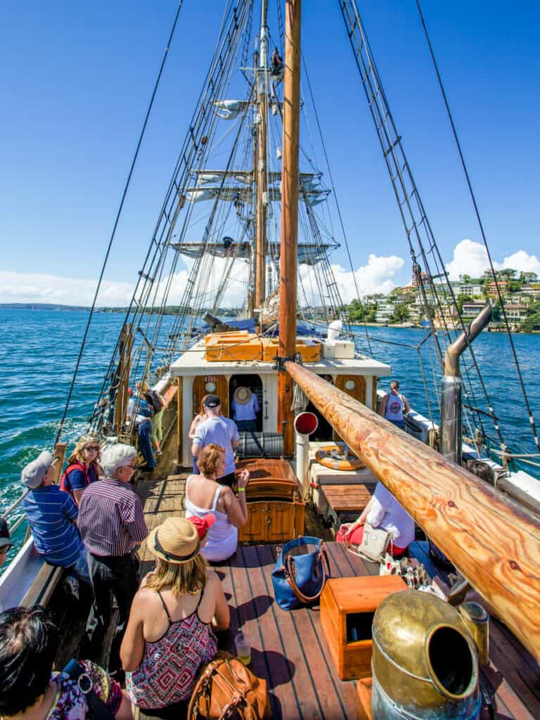 Passengers about the Sydney Harbour Tall Ship enjoying a day of sun and sailing in Sydney.