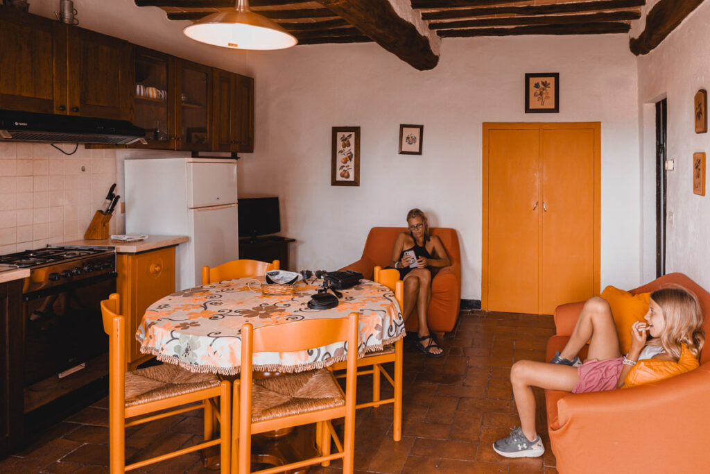 caz and craig sitting in living dining area of farmhouse cottage