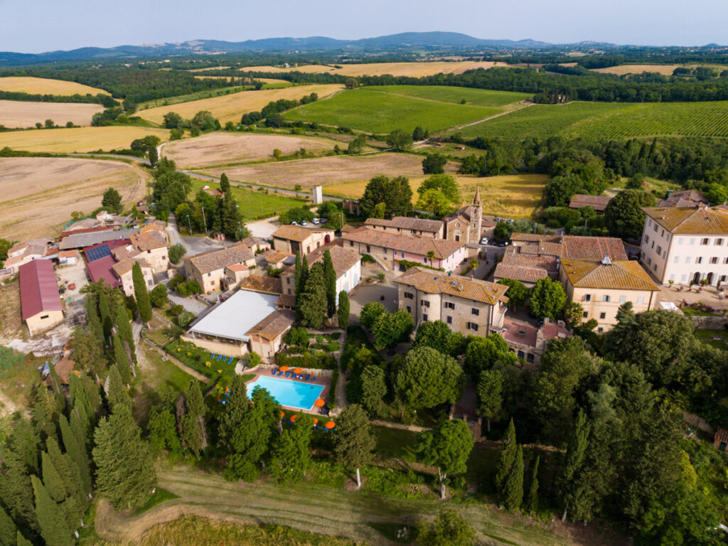 small stone village on hill with views of tuscany countryside and rolling hills