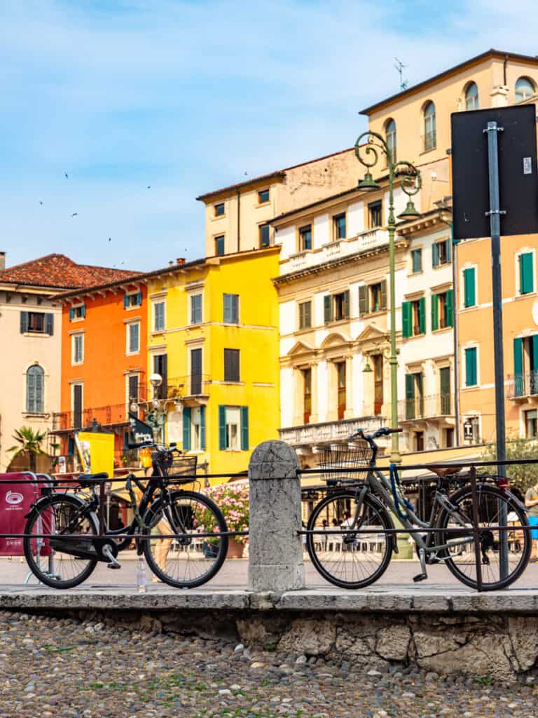 bikes leaning along fence with colorful homes in backgrond