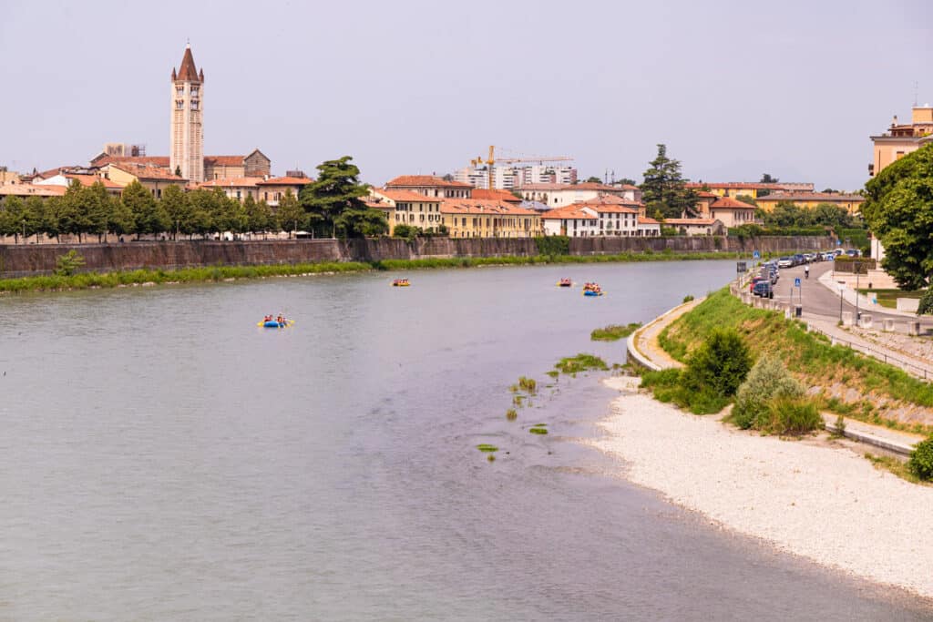 views of river aidge with small white sandy beach and church on the banks