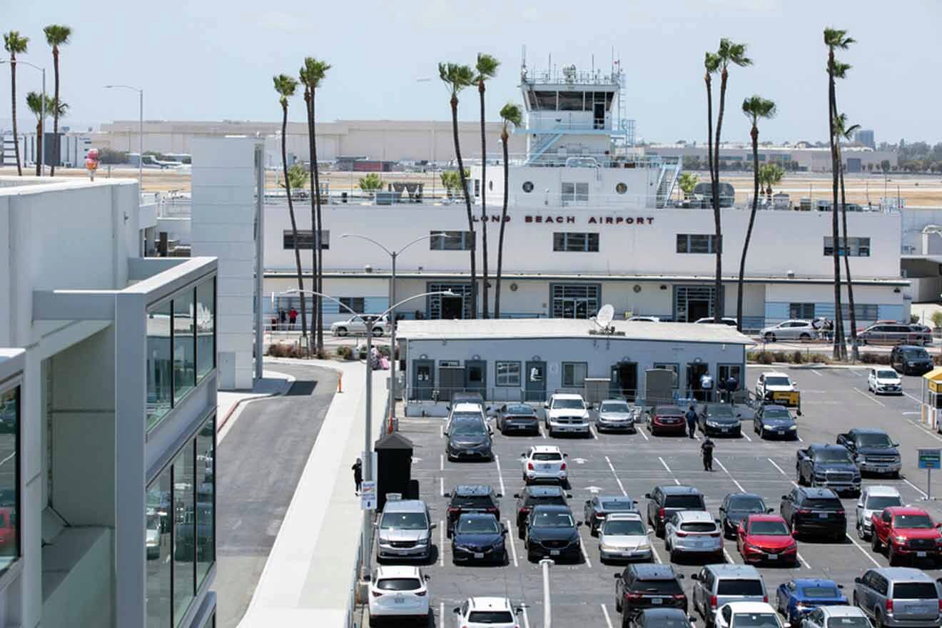 Cars are parked in a parking lot near an airport.