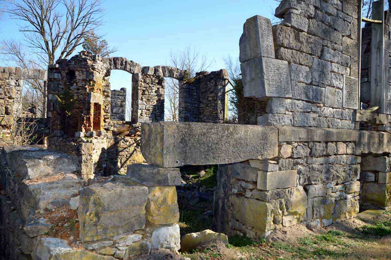 The ruins of an old castle in the middle of a field.