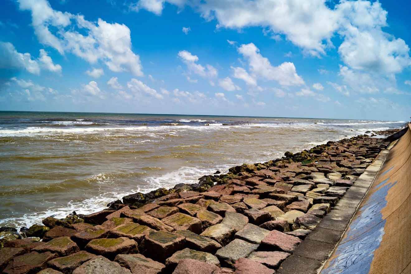 A beach with rocks and a cloudy sky.