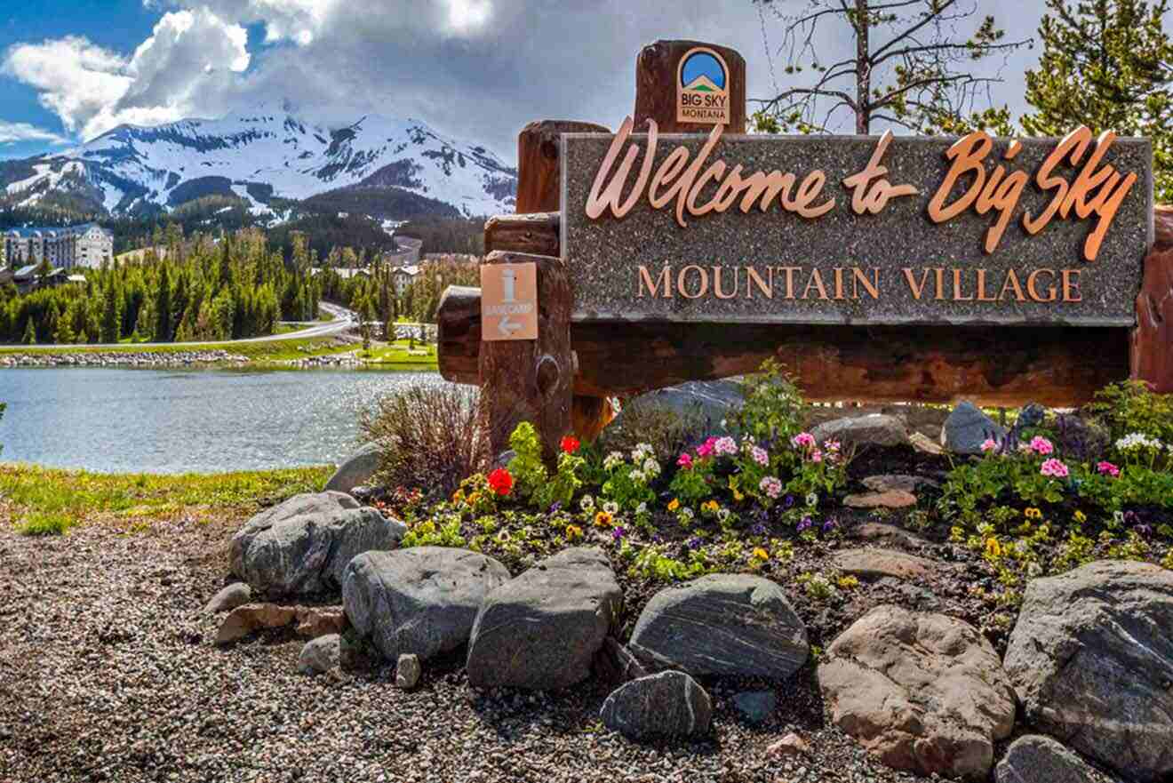 city sign with stones and flowers underneath it