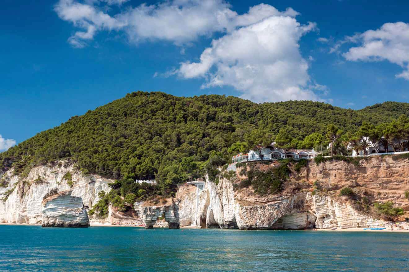 A cliff with a house on it next to the water.