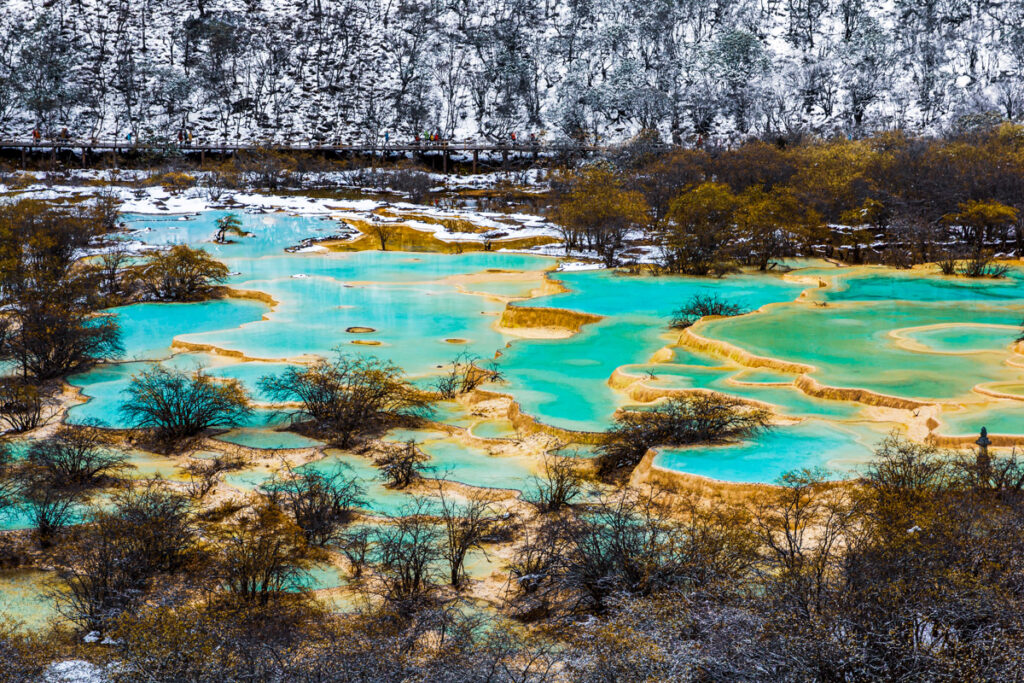 Huanglong Area with green pond in winter snow season, 