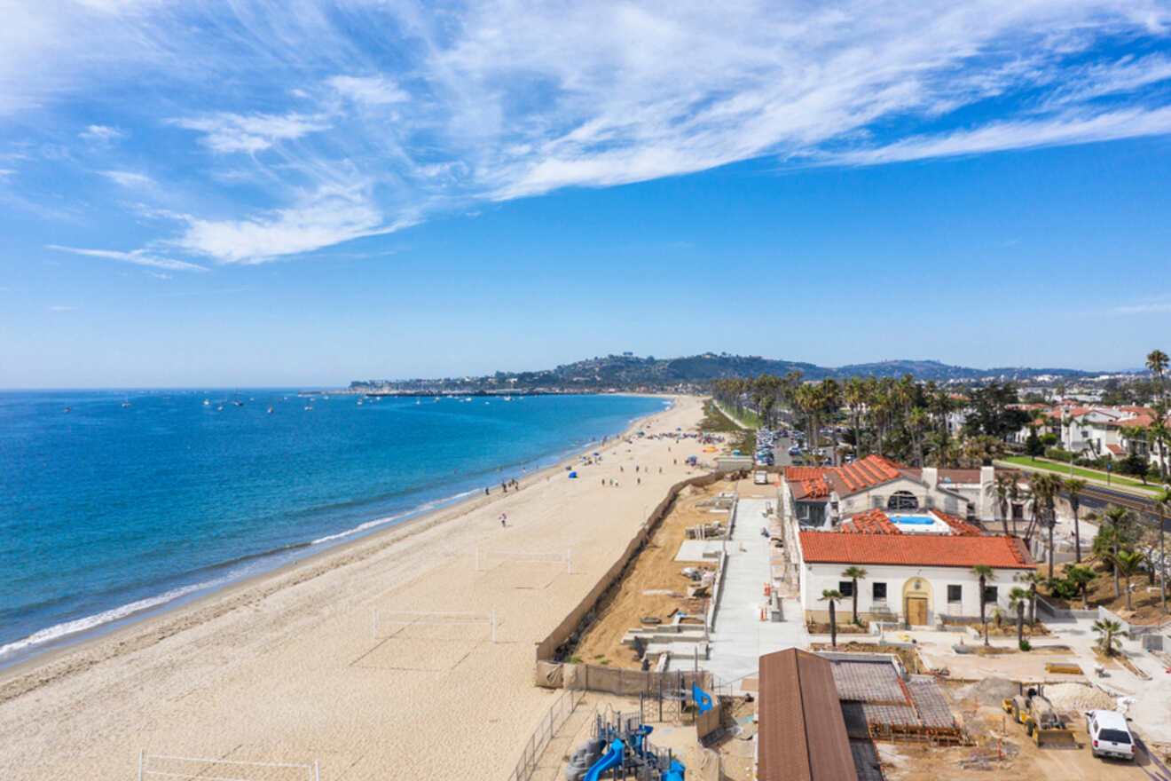 An aerial view of a beach and houses on a sunny day.