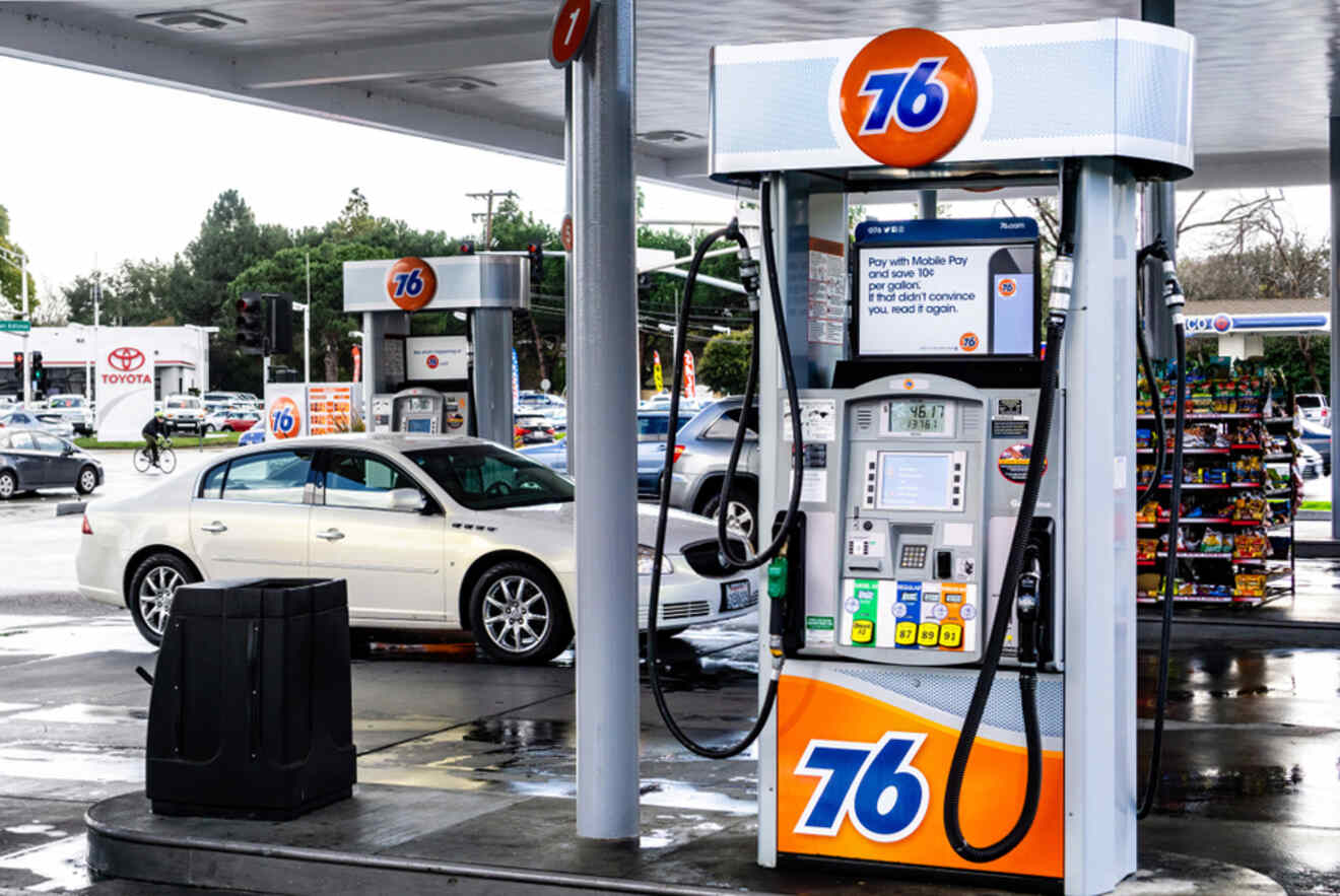 A gas station with a car parked next to it.