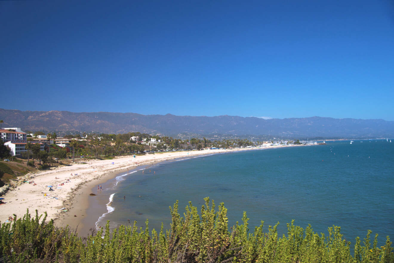 A beach with a lot of people on it.