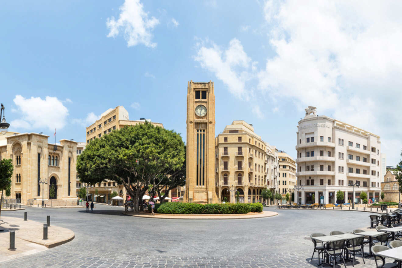 A clock tower in the middle of a city.