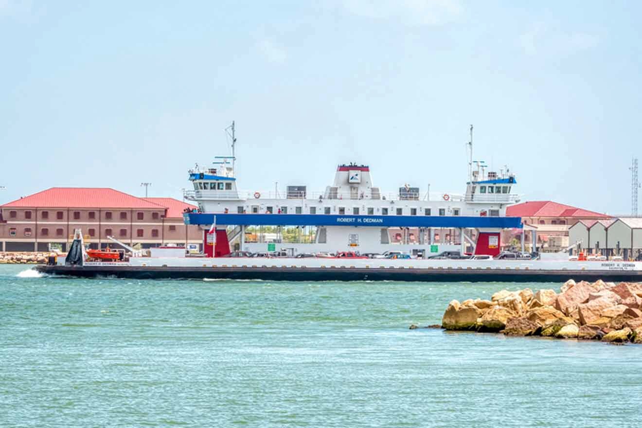 A ferry docked in the water near a building.