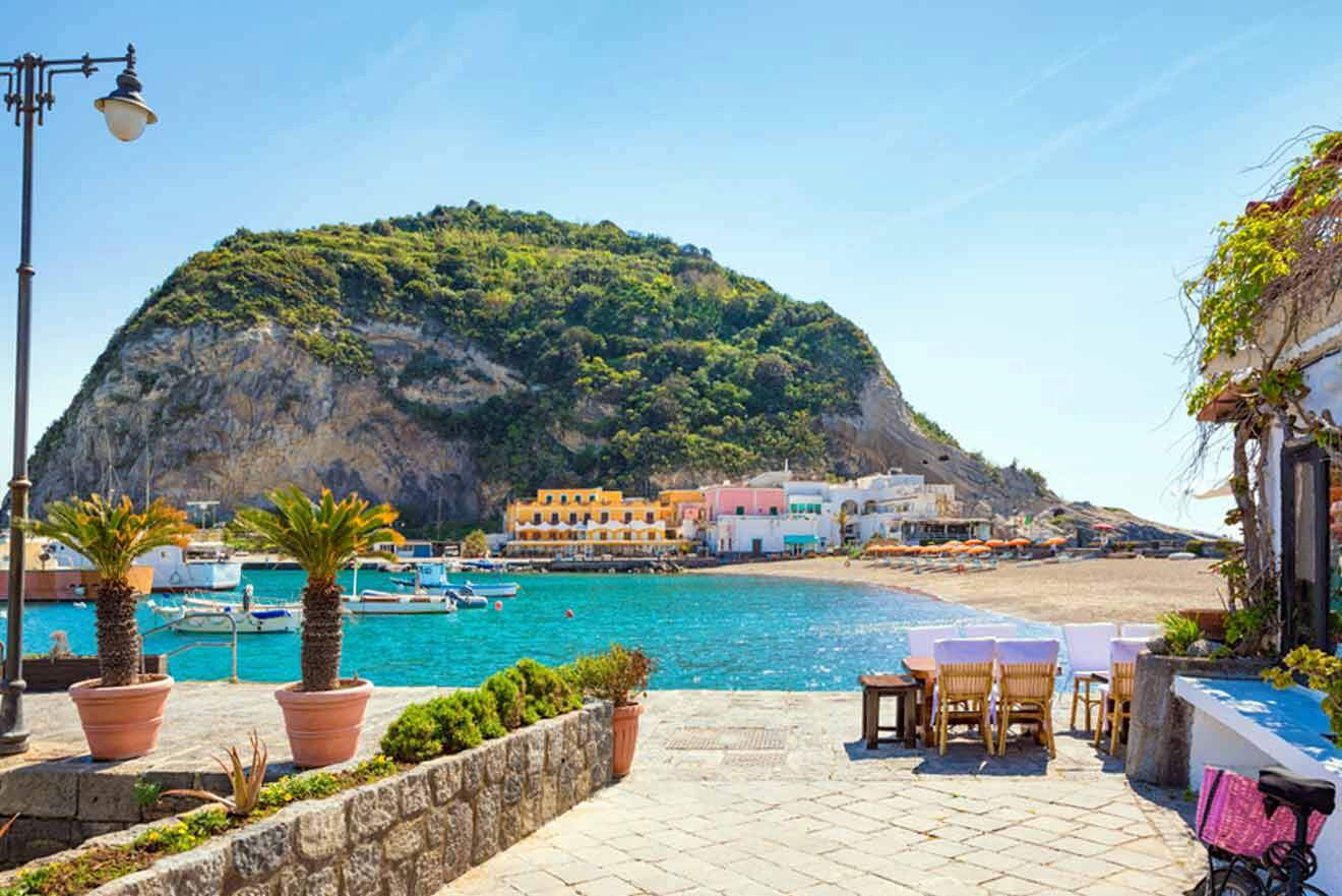 A view of a small town with a beach and a mountain in the background.