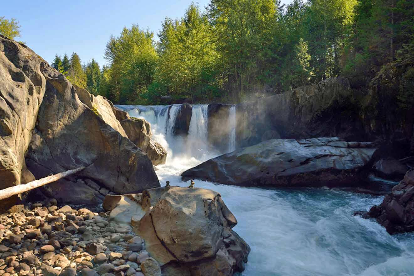 A waterfall surrounded by rocks and trees.