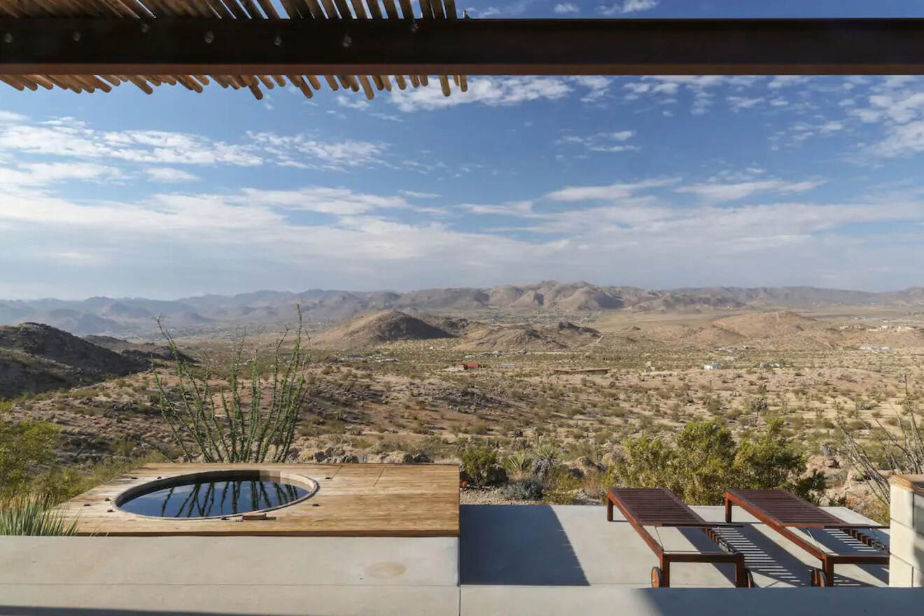 view over a desert with mountains in the distance and benches in the foreground