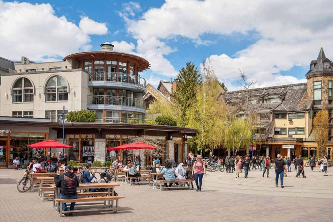 People are sitting at tables in a town square.