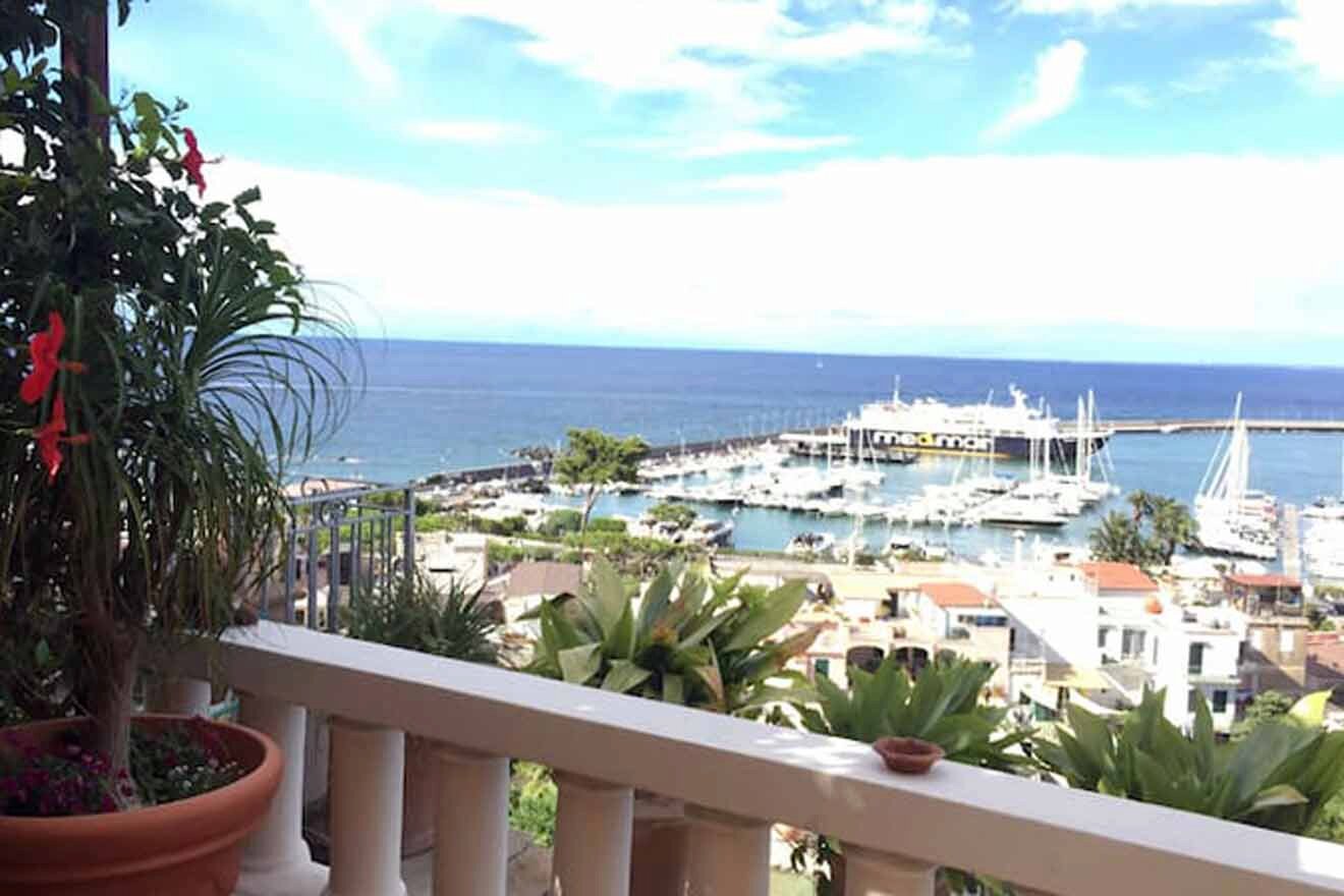 A balcony with a view of a harbor and boats.