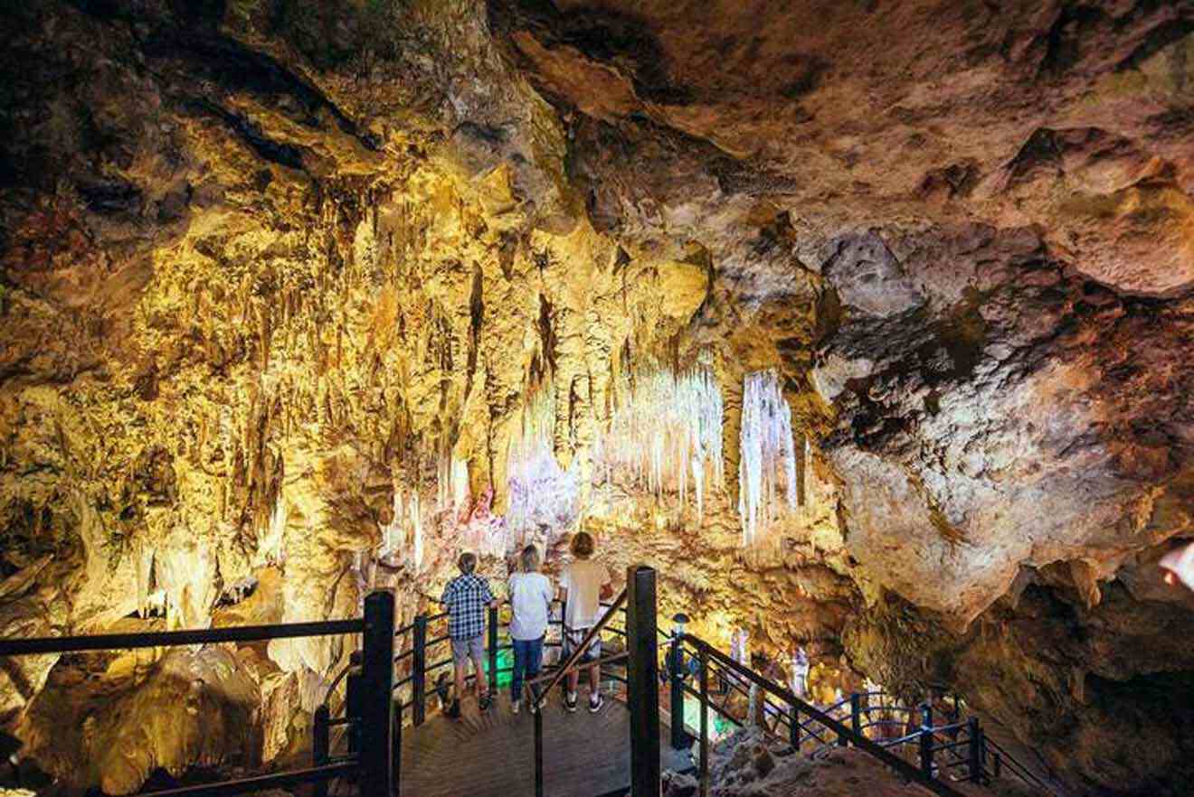 A group of people standing inside a cave.