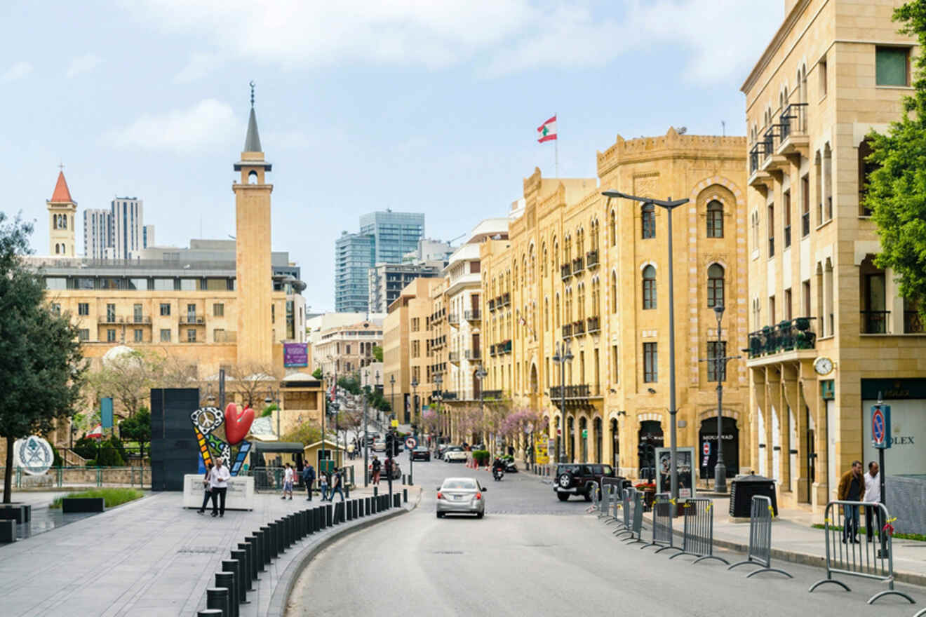 A street in a city with tall buildings and a clock tower.